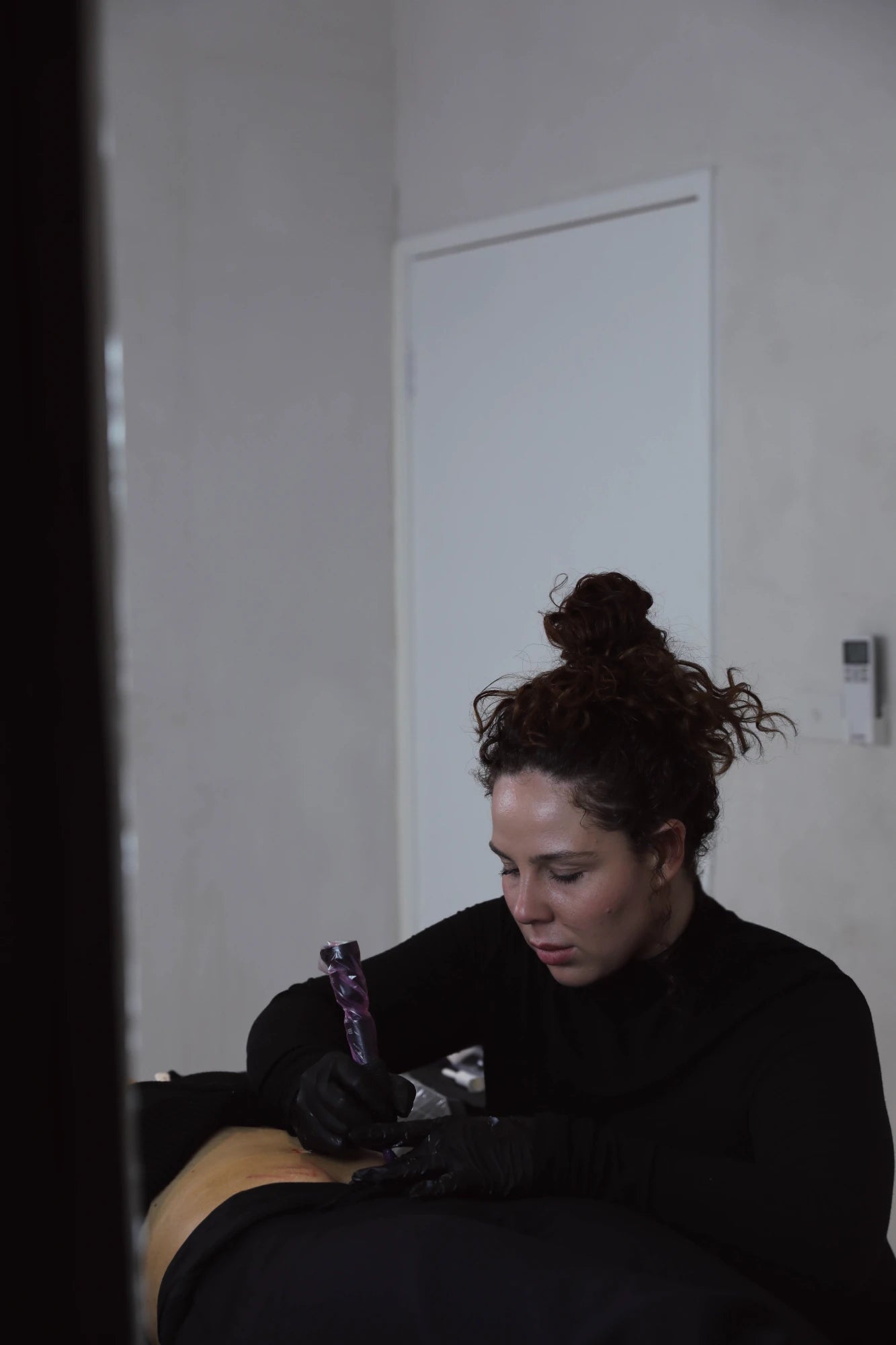 Demi tattooing a client in the Resolute Repair studio